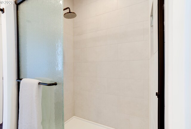 bathroom with a shower with door and vanity