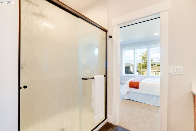 bathroom with walk in shower, tile patterned flooring, and vanity