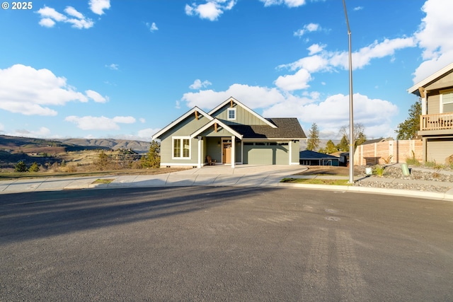 view of front of property with a garage and a mountain view