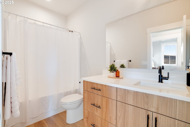 full bathroom featuring shower / bathtub combination with curtain, toilet, vanity, and wood-type flooring