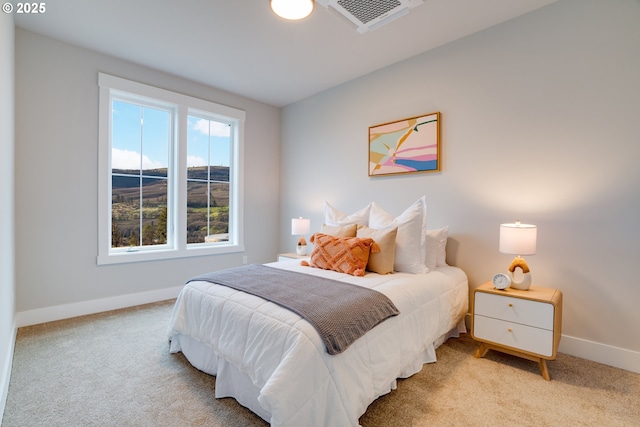 bedroom featuring light colored carpet