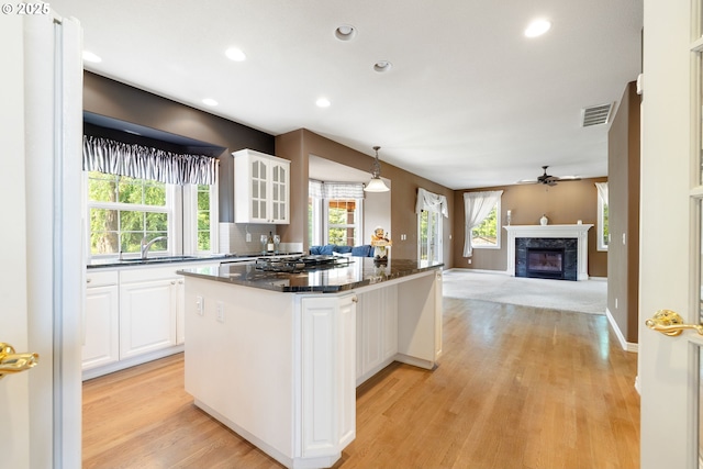 2103 N Teakwood St, Canby, OR 97013 - kitchen with ceiling fan, open floor plan, a center island, light wood-style floors, and recessed lighting