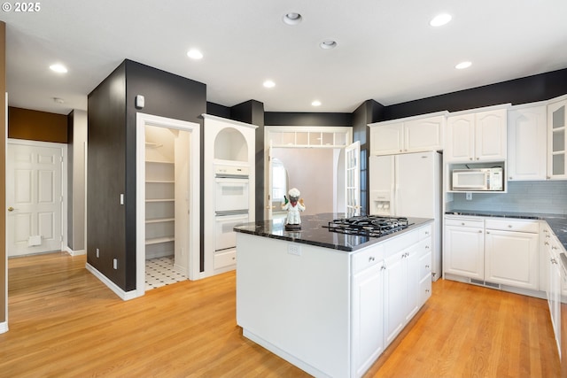2103 N Teakwood St, Canby, OR 97013 - kitchen with white appliances, a kitchen island, white cabinets, light wood finished floors, and recessed lighting
