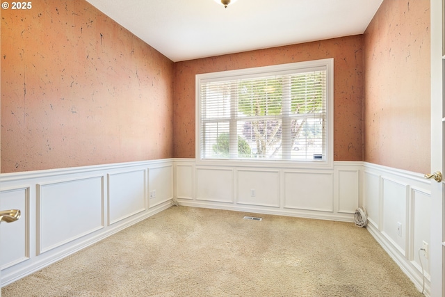 2103 N Teakwood St, Canby, OR 97013 - unfurnished room with a wainscoted wall, light colored carpet, and a decorative wall