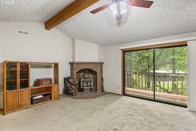 14216 NE 346th St, Battle Ground, WA 98604 - carpeted living room featuring a textured ceiling, a ceiling fan, and a wood stove