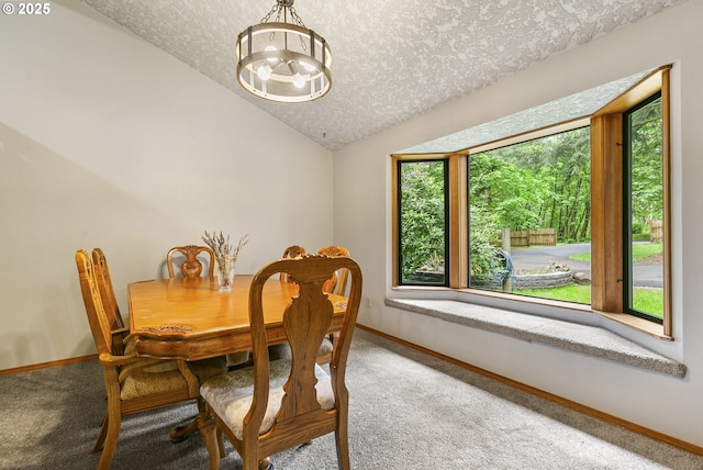 14216 NE 346th St, Battle Ground, WA 98604 - dining room featuring a chandelier, a textured ceiling, carpet flooring, vaulted ceiling, and baseboards