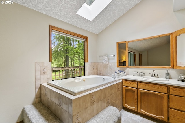 14216 NE 346th St, Battle Ground, WA 98604 - full bathroom featuring vaulted ceiling, a textured ceiling, a skylight, a bath, and vanity