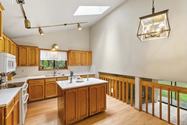 14216 NE 346th St, Battle Ground, WA 98604 - kitchen with white appliances, a sink, a skylight, decorative backsplash, and rail lighting