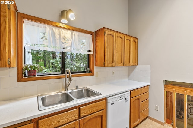 14216 NE 346th St, Battle Ground, WA 98604 - kitchen featuring dishwasher, a sink, backsplash, light countertops, and brown cabinets