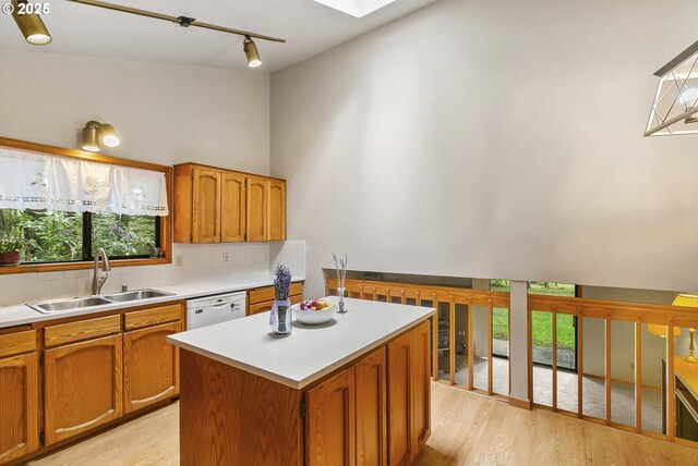 14216 NE 346th St, Battle Ground, WA 98604 - kitchen with a sink, tasteful backsplash, light wood-style floors, rail lighting, and light countertops