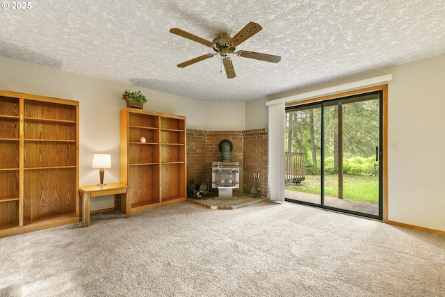 14216 NE 346th St, Battle Ground, WA 98604 - unfurnished living room with a wood stove, carpet, a textured ceiling, a ceiling fan, and baseboards