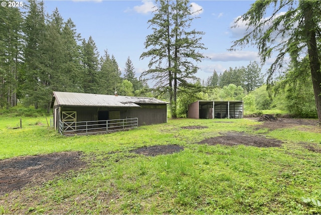 14216 NE 346th St, Battle Ground, WA 98604 - view of yard featuring an outbuilding, a detached carport, an outdoor structure, and a forest view