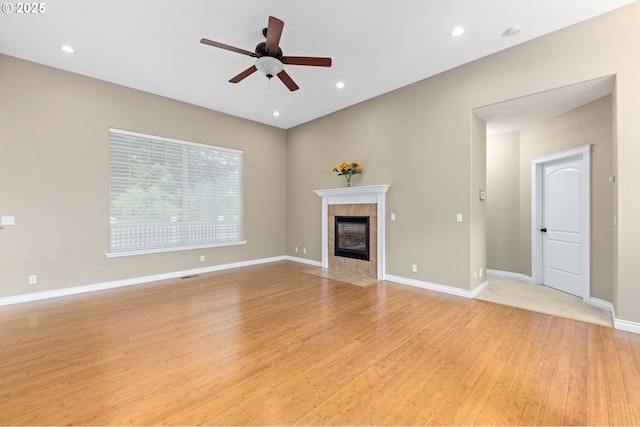 115 Duane Ct, Myrtle Creek, OR 97457 - unfurnished living room featuring light wood finished floors, a ceiling fan, a tiled fireplace, baseboards, and recessed lighting