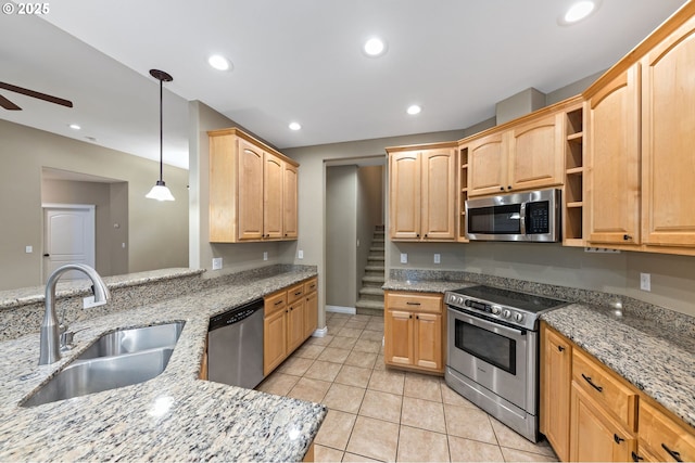 115 Duane Ct, Myrtle Creek, OR 97457 - kitchen with stainless steel appliances, a sink, a ceiling fan, light tile patterned flooring, and light stone countertops
