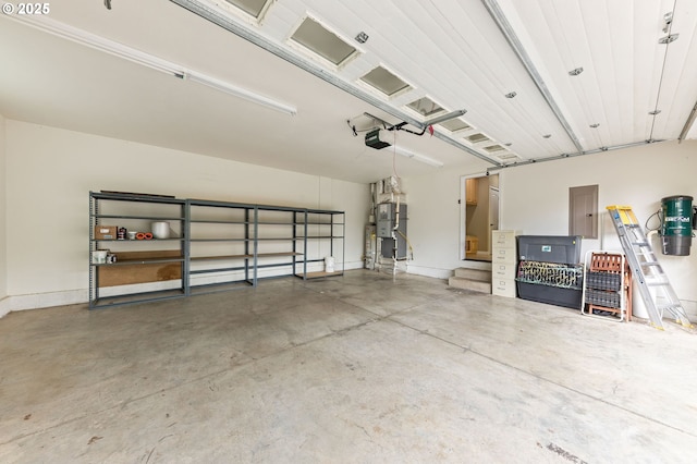 115 Duane Ct, Myrtle Creek, OR 97457 - garage with a garage door opener, electric panel, heating unit, a central vacuum unit, and baseboards