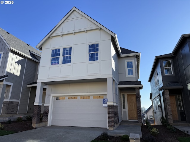 view of front facade with a garage, driveway, brick siding, and stucco siding