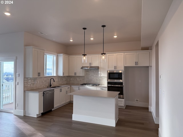 kitchen with a center island, hanging light fixtures, plenty of natural light, appliances with stainless steel finishes, and white cabinets