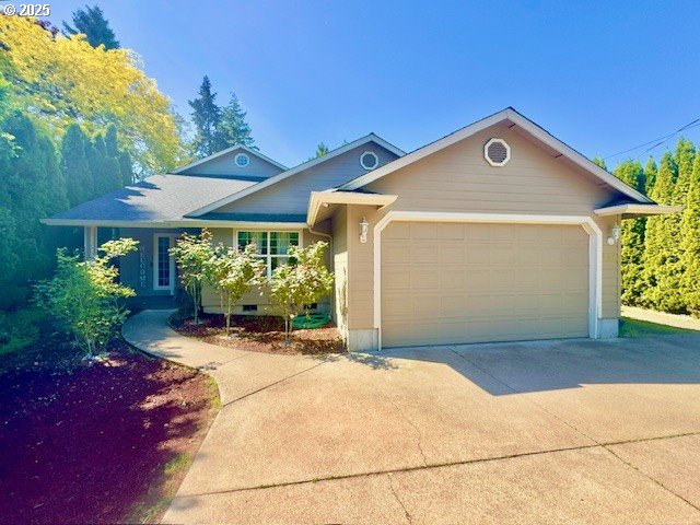 view of front of home with concrete driveway and a garage