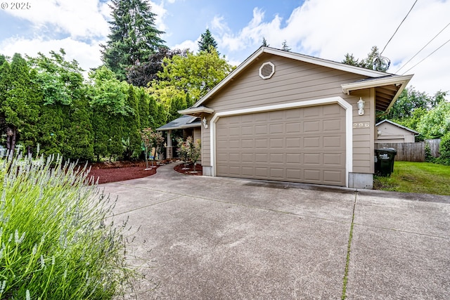 view of home's exterior with a garage and an outbuilding