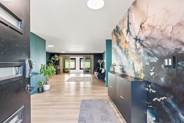 entrance foyer with french doors and light hardwood / wood-style flooring