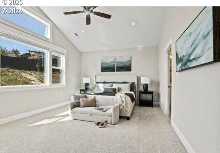 carpeted bedroom with lofted ceiling and ceiling fan