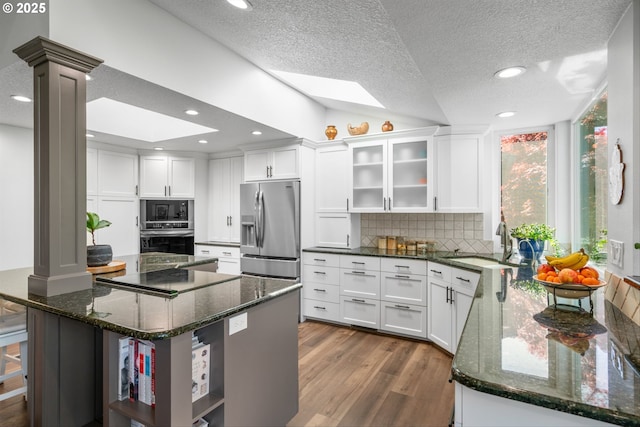 1433 SE 49th Ct, Hillsboro, OR 97123 - kitchen with decorative backsplash, dark wood finished floors, a sink, black appliances, and white cabinetry