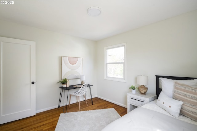 bedroom featuring wood finished floors and baseboards