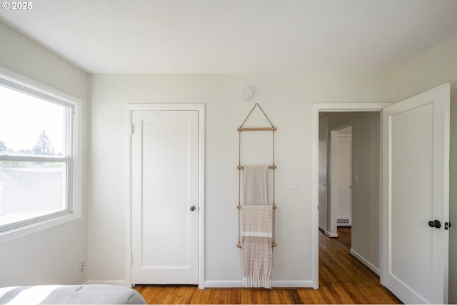 bedroom featuring wood finished floors and baseboards