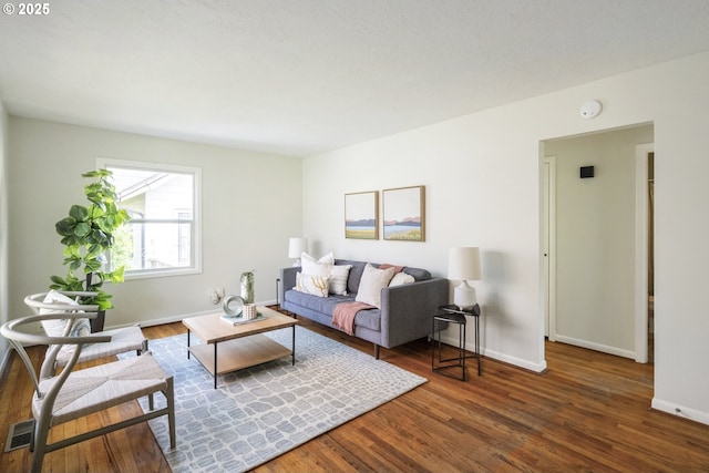 living room featuring baseboards and wood finished floors