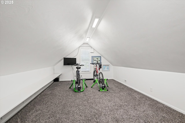 unfurnished office with lofted ceiling, baseboards, and carpet