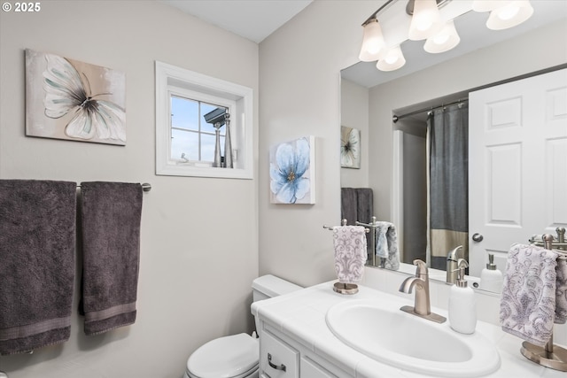 bathroom with toilet, vanity, and a shower with curtain