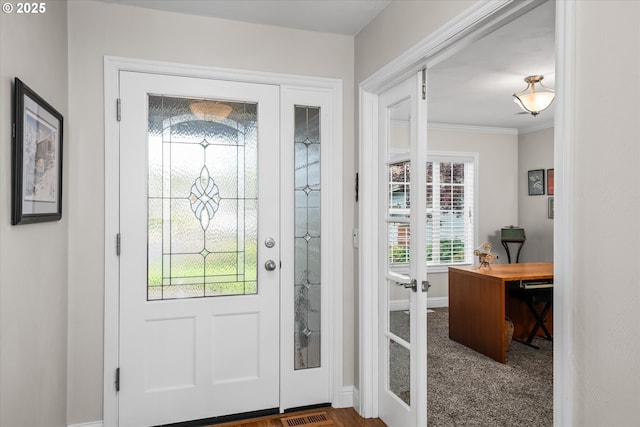 entryway featuring baseboards and ornamental molding