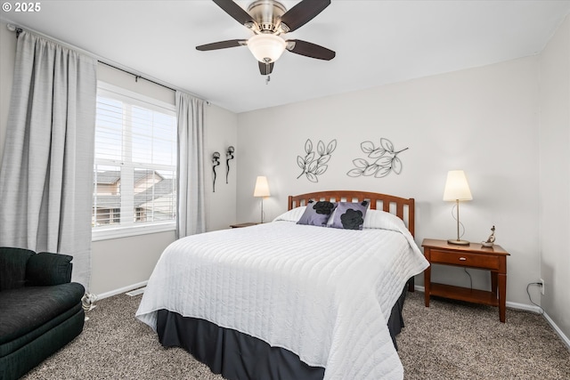 carpeted bedroom featuring baseboards, multiple windows, and ceiling fan