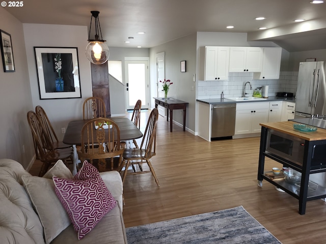 23538 NW Saint Helens Rd Unit S5, Portland, OR 97231 - dining space featuring light wood-type flooring, baseboards, and recessed lighting