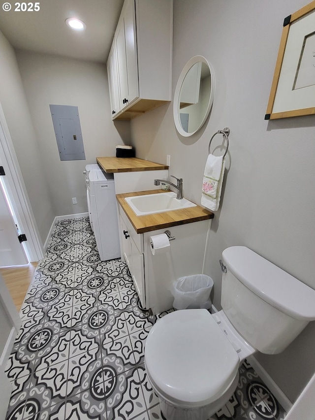23538 NW Saint Helens Rd Unit S5, Portland, OR 97231 - bathroom with toilet, baseboards, vanity, electric panel, and recessed lighting