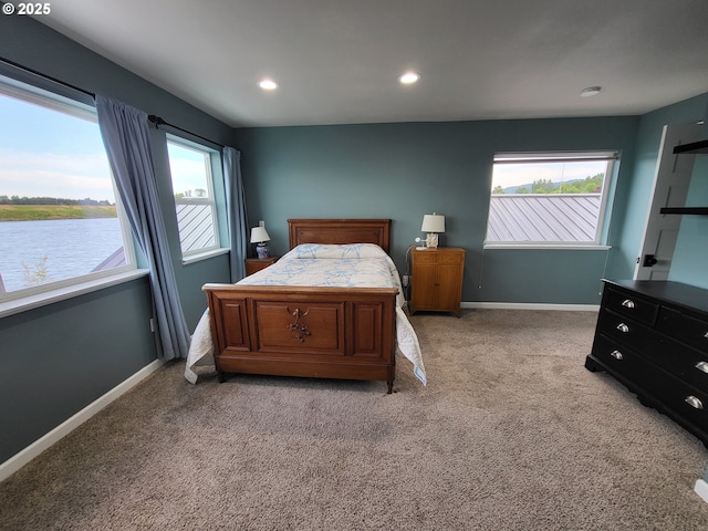 23538 NW Saint Helens Rd Unit S5, Portland, OR 97231 - bedroom with multiple windows, light colored carpet, baseboards, recessed lighting, and a water view