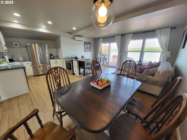 23538 NW Saint Helens Rd Unit S5, Portland, OR 97231 - dining space featuring a wall mounted air conditioner, recessed lighting, and light wood-style flooring