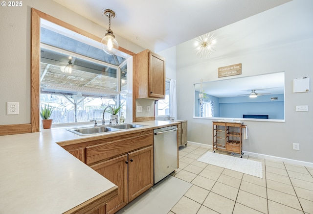 kitchen featuring a sink, pendant lighting, light countertops, and dishwasher