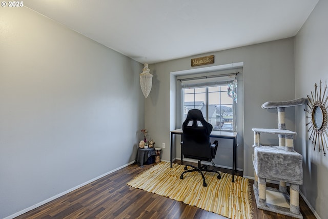 home office featuring wood finished floors and baseboards