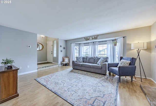 living room with light wood finished floors and baseboards