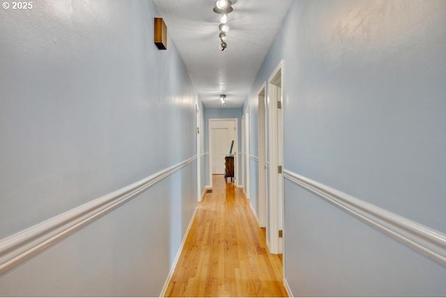 corridor with light wood-style floors