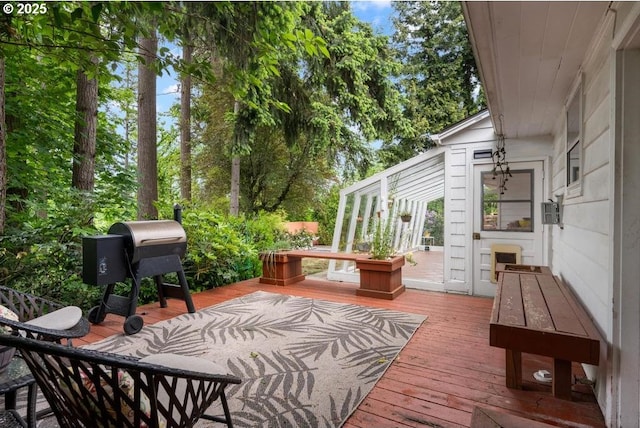 wooden terrace featuring a grill