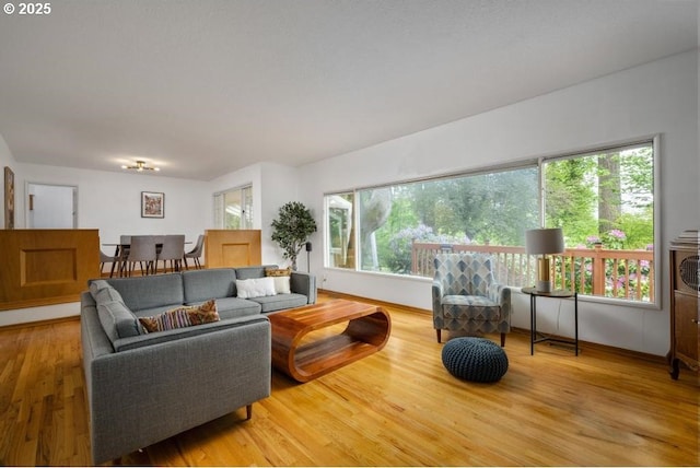 living area with wood finished floors and baseboards