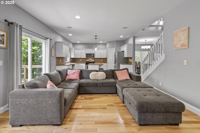 14818 NE 23rd Ave, Vancouver, WA 98686 - living room with a chandelier, light wood-style flooring, stairway, and recessed lighting