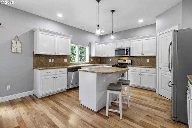 14818 NE 23rd Ave, Vancouver, WA 98686 - kitchen with stainless steel appliances, white cabinetry, recessed lighting, and light wood-type flooring