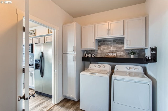 12998 SW Kostel Ln, Portland, OR 97224 - laundry area featuring washer and dryer and light wood-type flooring