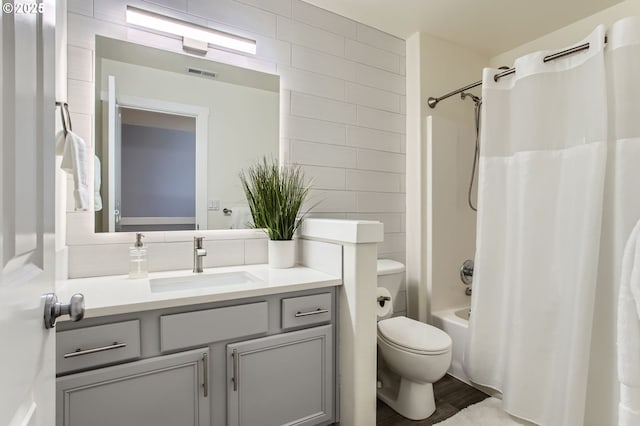 12998 SW Kostel Ln, Portland, OR 97224 - bathroom with vanity, tile walls, toilet, and shower / bath combo with shower curtain