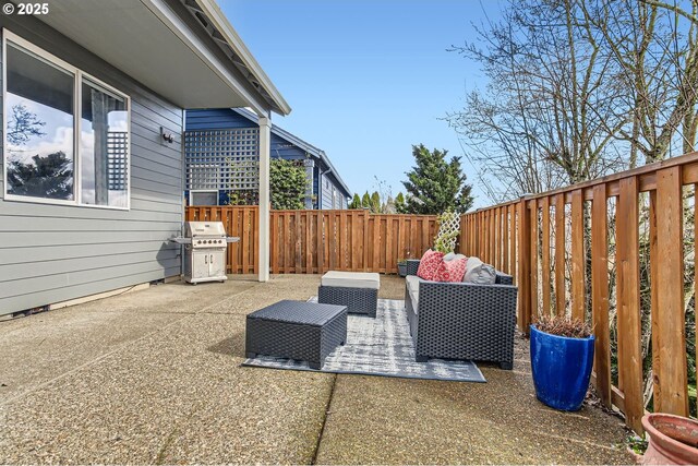 12998 SW Kostel Ln, Portland, OR 97224 - fenced backyard with grilling area, a patio area, and outdoor lounge area