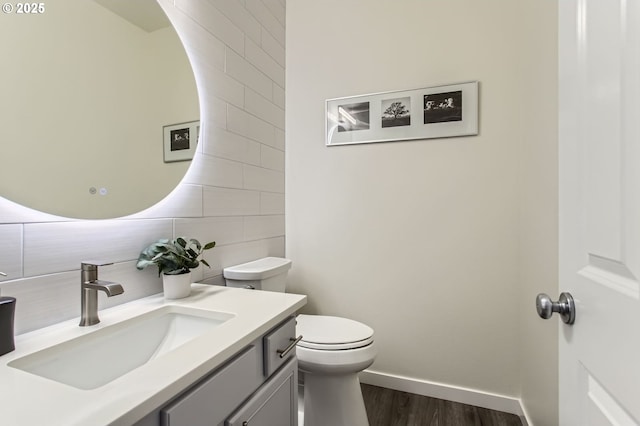 12998 SW Kostel Ln, Portland, OR 97224 - bathroom featuring decorative backsplash, toilet, vanity, wood finished floors, and baseboards
