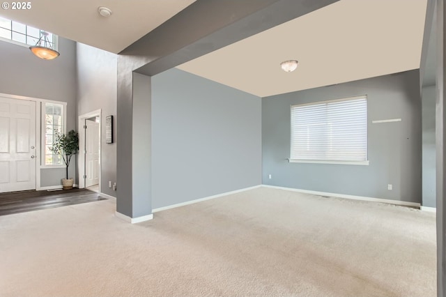 12998 SW Kostel Ln, Portland, OR 97224 - foyer entrance featuring carpet flooring, baseboards, and a towering ceiling